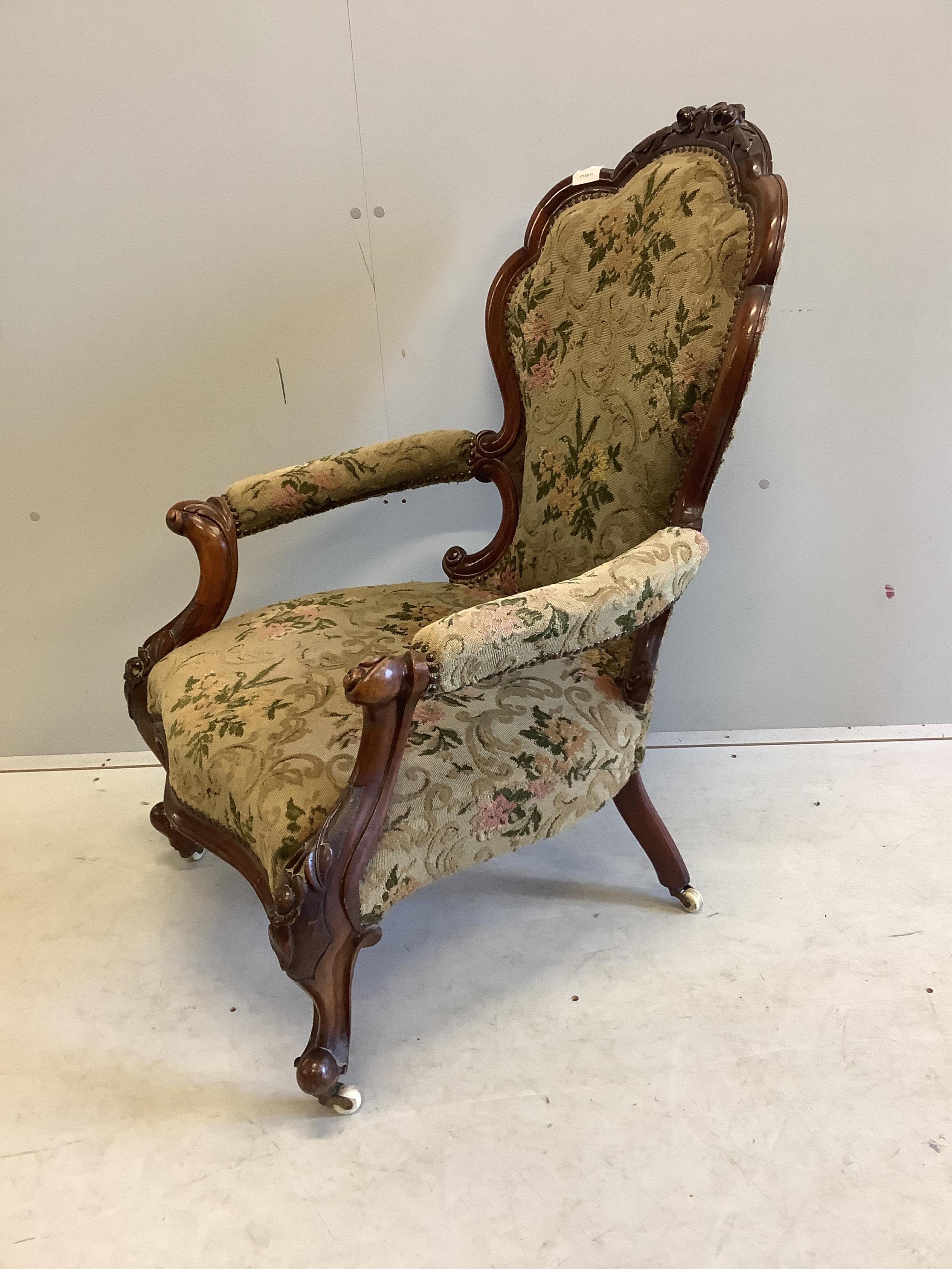 A Victorian walnut upholstered open armchair, width 66cm, depth 60cm, height 100cm. Condition - good